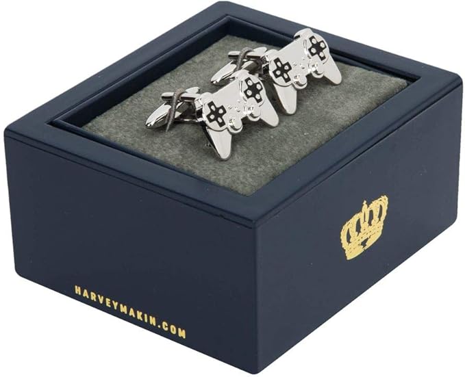 Pair of silver game controller cufflinks in a black box with 'Harvey Makin' branding.