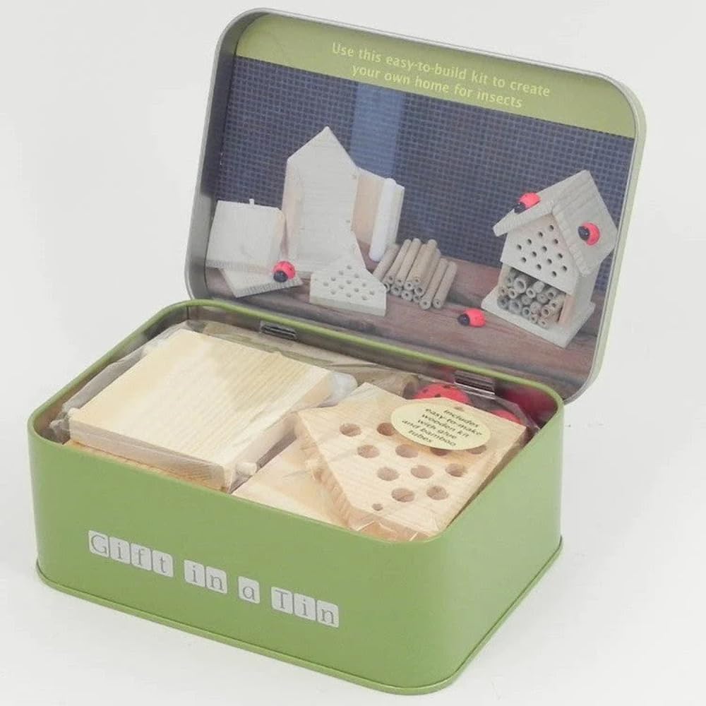 Green tin kit with wooden components for building insect habitats on a white background