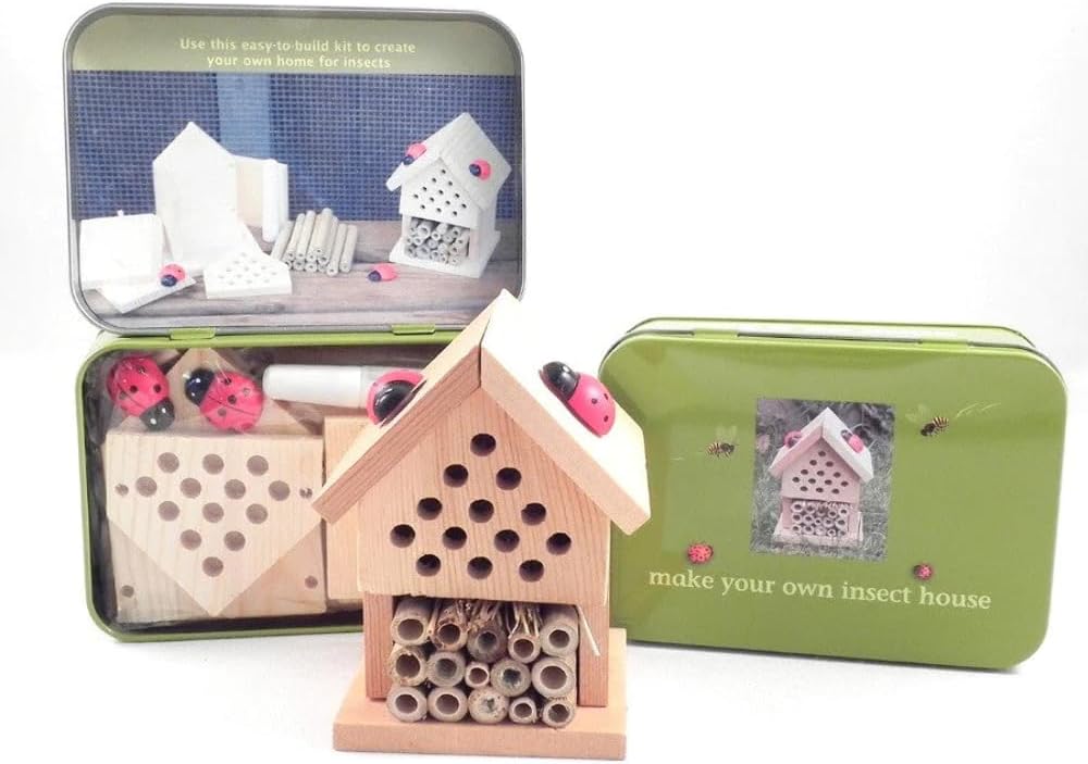 Wooden insect house kit with tools and components in a green tin on a white background