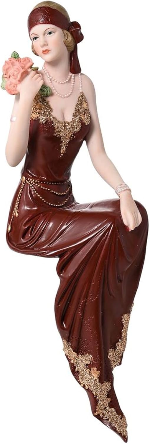 Statue of a woman in a detailed dress with gold accents on a white background