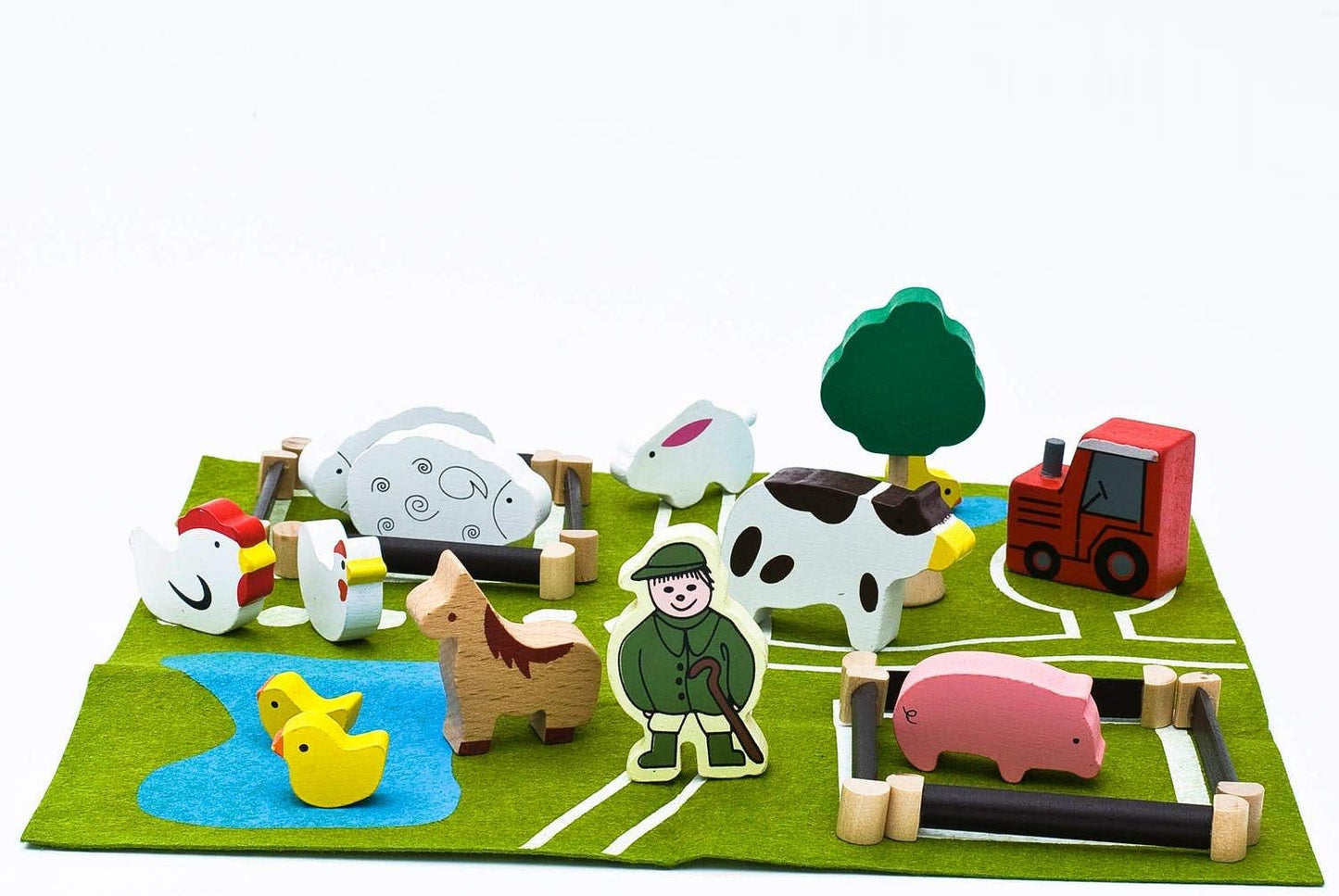 Set of wooden farm animals and a farmer on a green play mat with white lines.