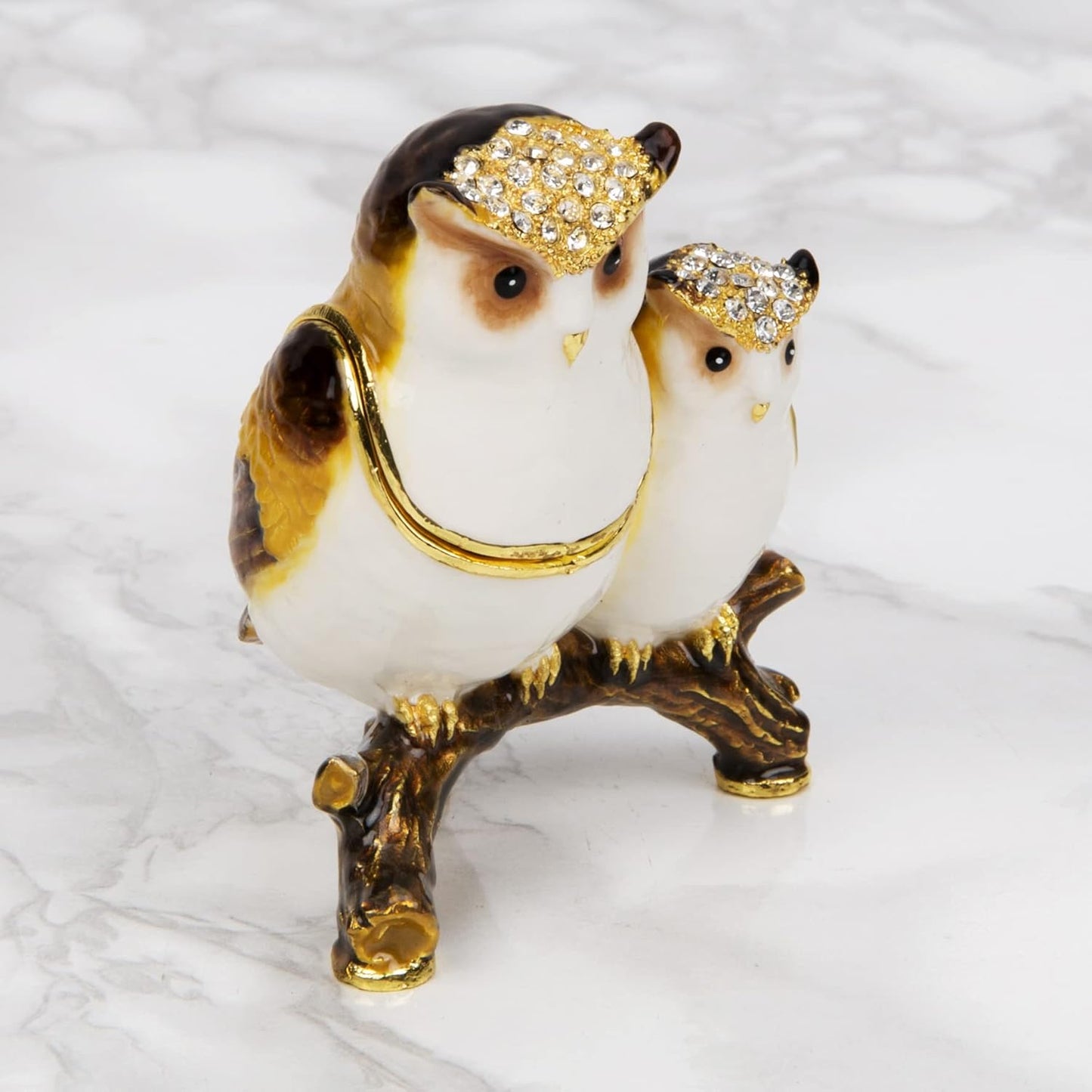 Decorative owl figurine with jewelled hats on a white background