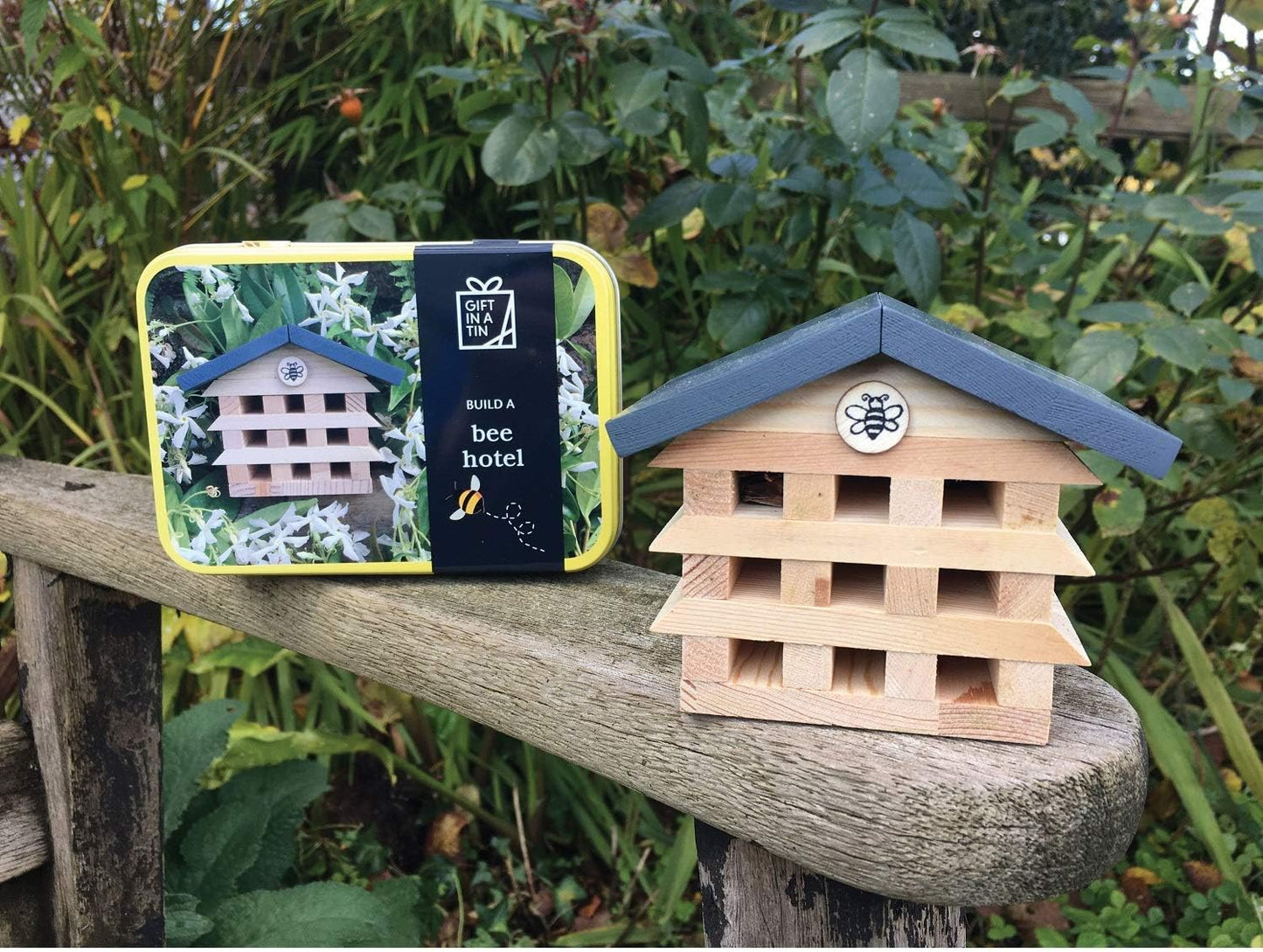 Bee hotel with packaging on a wooden surface outdoors