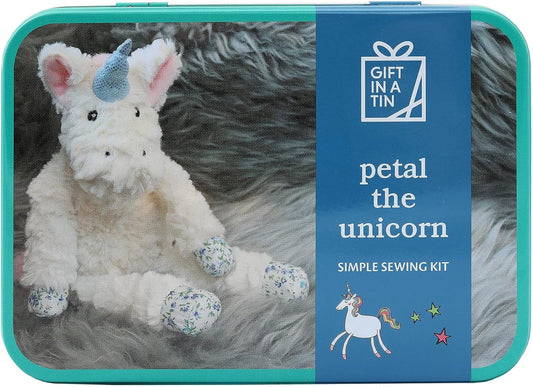 Unicorn plush toy in a tin with 'Gift in a Tin' branding and text about a sewing kit.