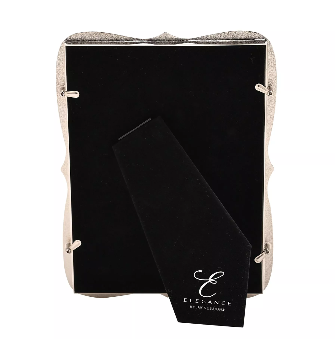 Black back of frame with 'Elegance by impressions' branding in a beige holder on a white background