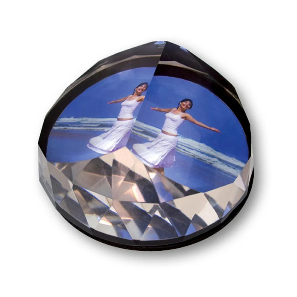 Crystal ball with a printed image of a woman in a white dress on a blue background