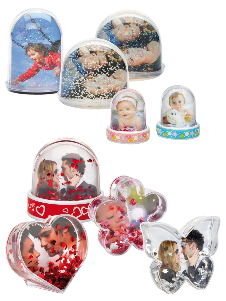 Collection of decorative photo snow globes with various designs on a white background