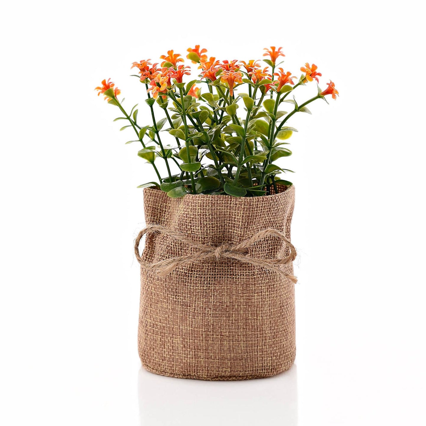 A small artificial plant packaged in a brown hessian bag with a rustic design, containing orange and green artificial flowers.