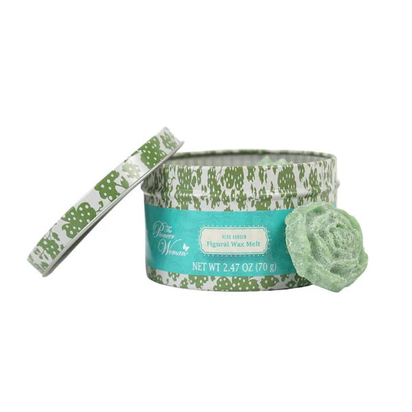 Green and white wax melt container with a decorative ribbon on a white background