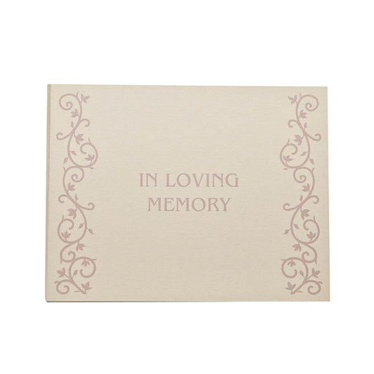 A cream-colored book with a decorative font and floral patterns, titled 'In Loving Memory' on the cover.