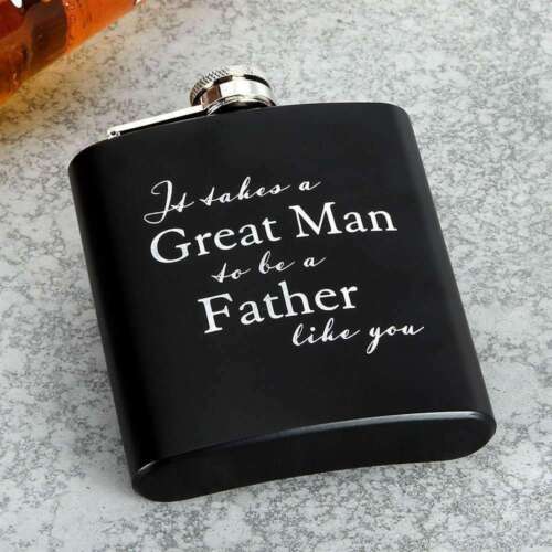 A black metal hip flask with white text that reads 'It takes a Great Man to be a Father like you'. It is presented on a textured grey surface.