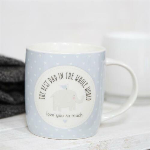 A ceramic mug with a pastel blue color and white heart pattern, featuring an elephant and a blue bird design, along with the text 'THE BEST DAD IN THE WHOLE WORLD - LOVE YOU SO MUCH'.