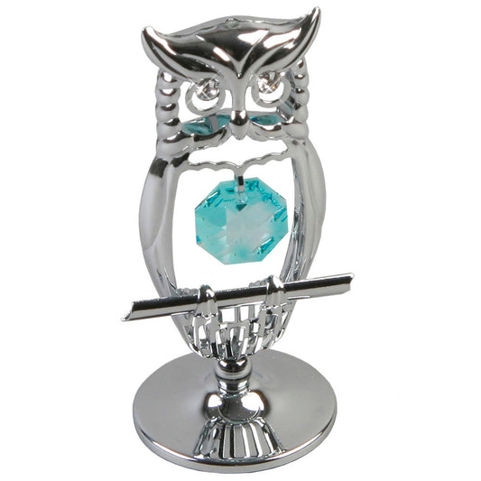 A silver chrome plated owl ornament with a blue aqua marine crystal embellishment in its nest.