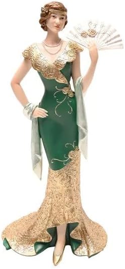 Decorative figurine of a woman in an elegant green and gold gown with a fan, on a white background.