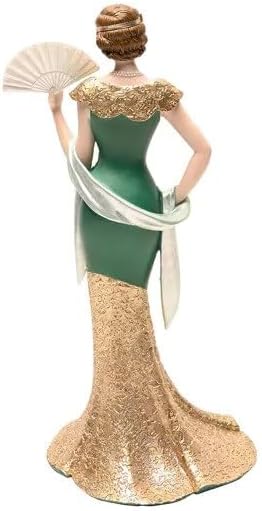 Decorative figurine of a woman in an elegant dress with a fan on a white background