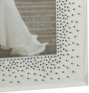Decorative picture frame with rhinestone embellishments on a wooden surface