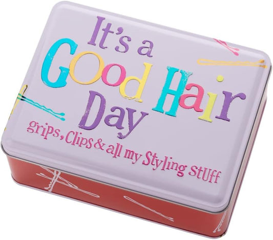 Tin box with 'It's a Good Hair Day' text and colorful hair accessories on a white background