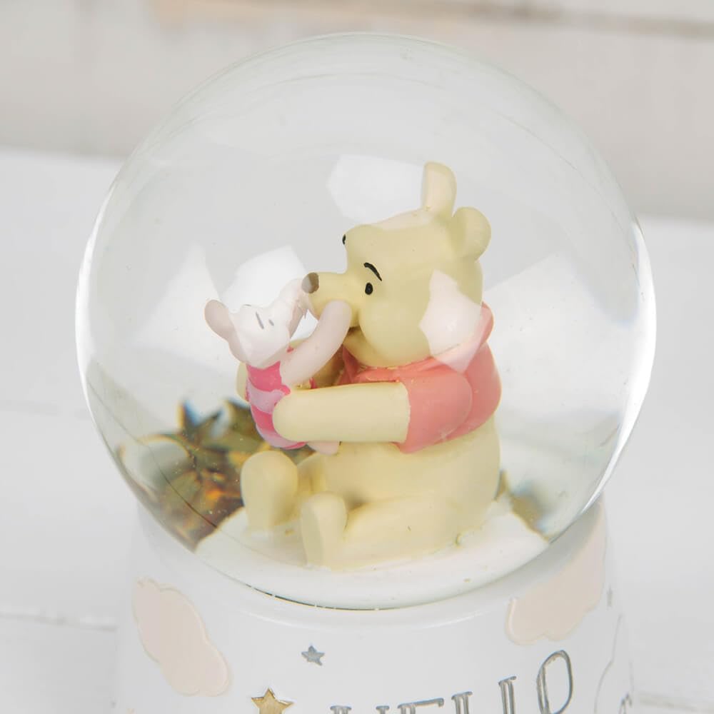 Snow globe with Winnie the Pooh and Piglet inside, on a light background