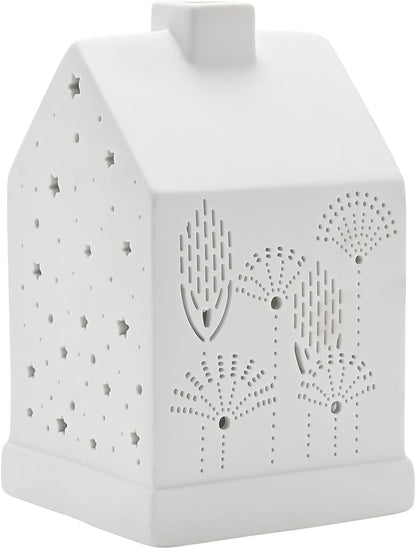 A white ceramic house-shaped night light with laser-cut star and tree patterns, shown on a plain white background.