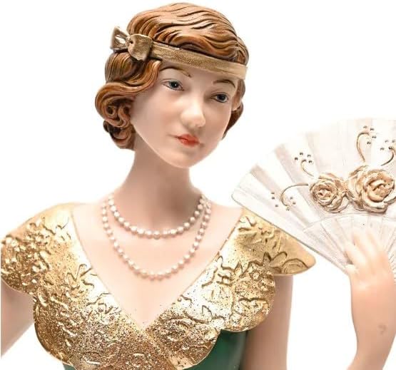 Decorative figurine of a woman in a gold dress and pearl necklace on a white background