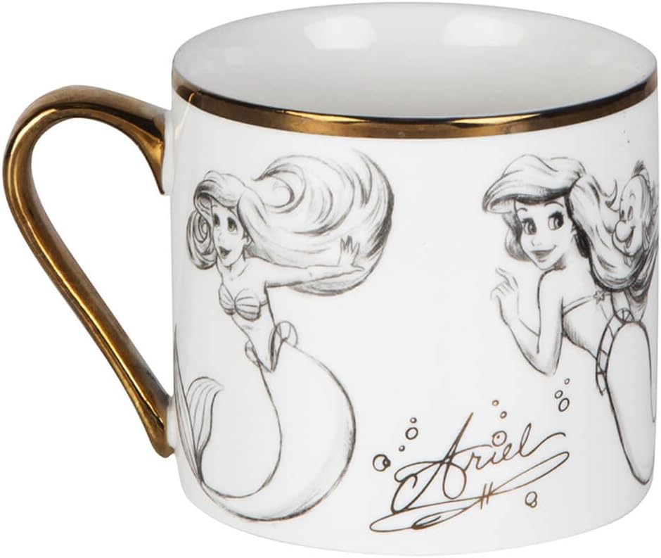 Mug with illustrations of a mermaid and gold handle on a white background