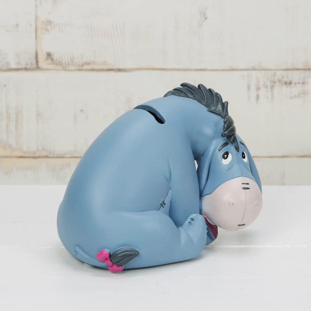 Eeyore Dumbo Money Box in front of brick wall side profile