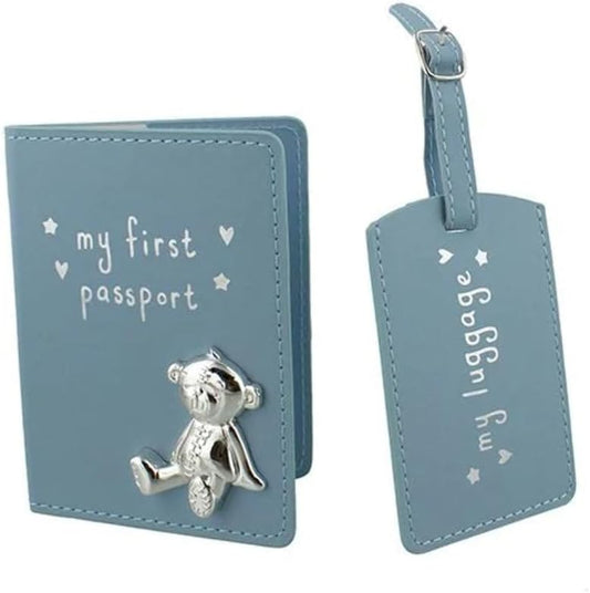 Blue 'my first passport' holder with teddy bear charm and matching 'my luggage' tag on a white background