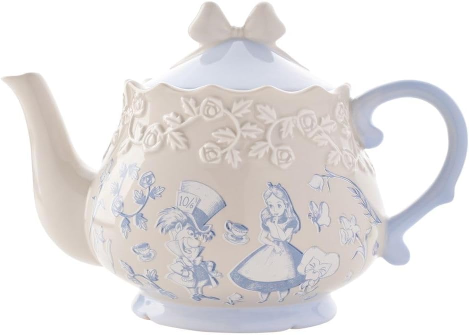 Decorative teapot with Alice in Wonderland design on a white background