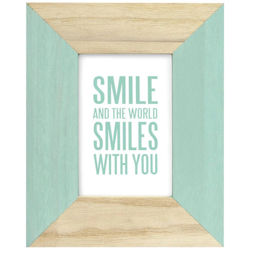 Wooden picture frame with motivational quote 'Smile and the world smiles with you' on a white background