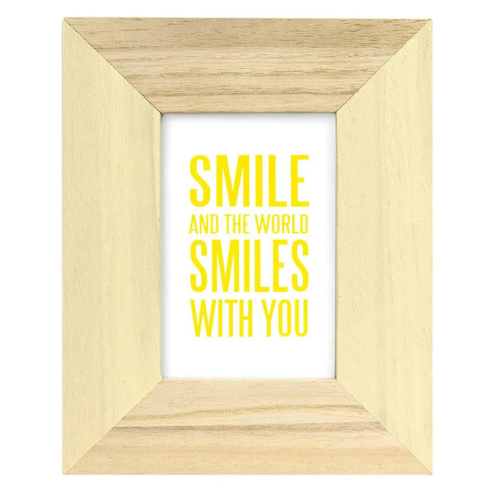 Wooden frame with yellow text 'SMILE AND THE WORLD SMILES WITH YOU' on a white background