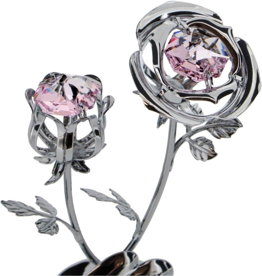Silver flower-shaped object with pink gemstones on a white background