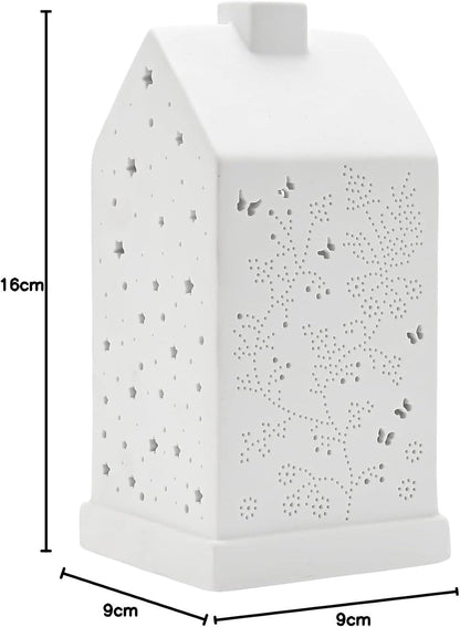 White house-shaped ceramic night light with star and floral cutout patterns, shown with dimension lines indicating 16cm height and 9cm width and depth.