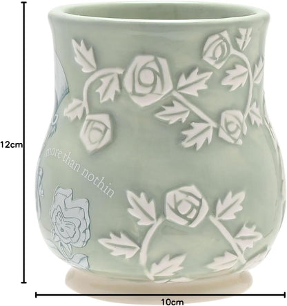 Green ceramic mug with floral patterns and 'more than nothin' text, shown with measurements.