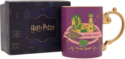 A purple Harry Potter Honeyduke Wizarding Favourite mug with a gold handle and gold rim, shown next to its dark blue branded gift box.