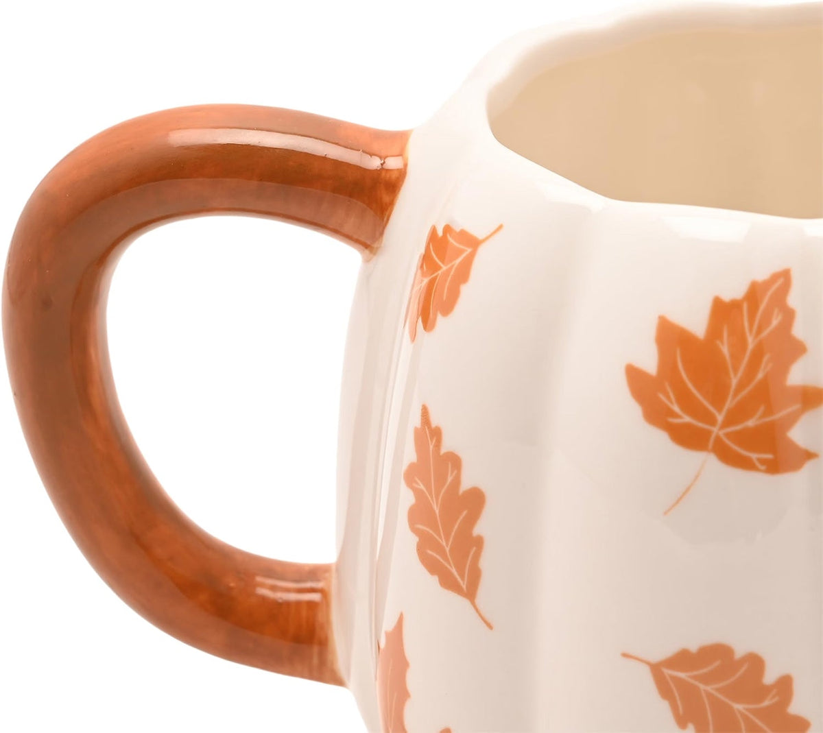 Close-up of a white ceramic mug with a glossy brown handle and orange leaf pattern on the side, shown against a white background.