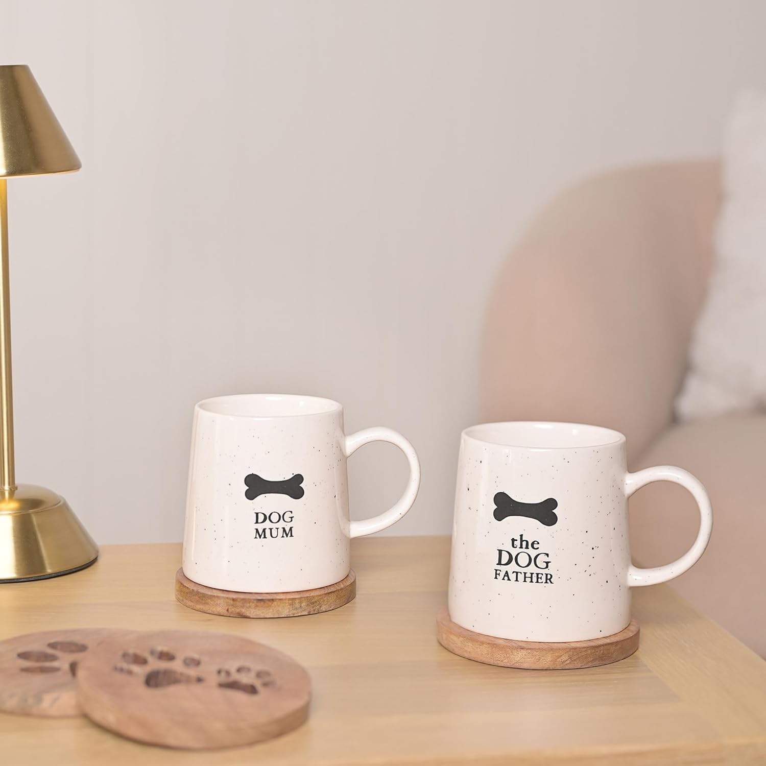 Two mugs with 'Dog Mum' and 'The Dog Father' text on a wooden surface.