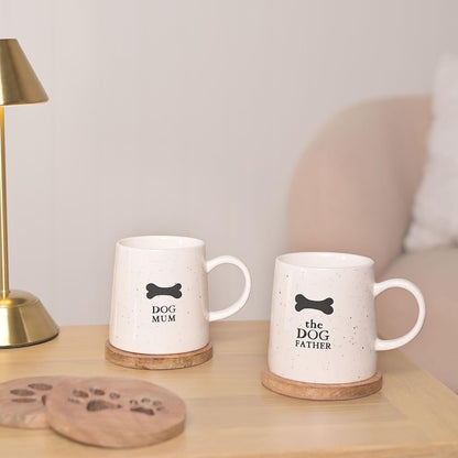 Two mugs with 'Dog Mum' and 'The Dog Father' text on a wooden surface.