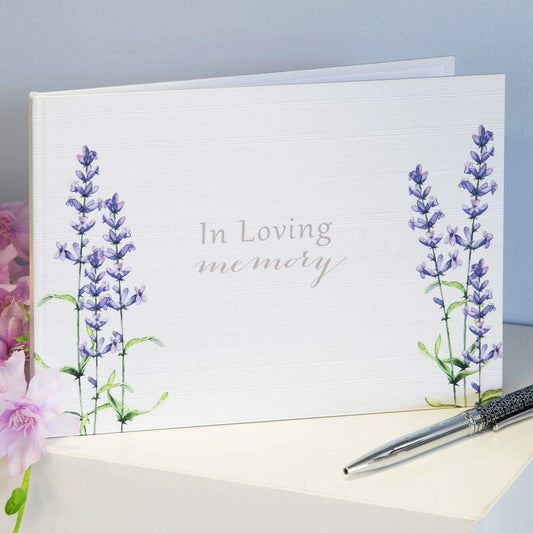 Book with lavender design and 'In Loving Memory' text on a light blue background.