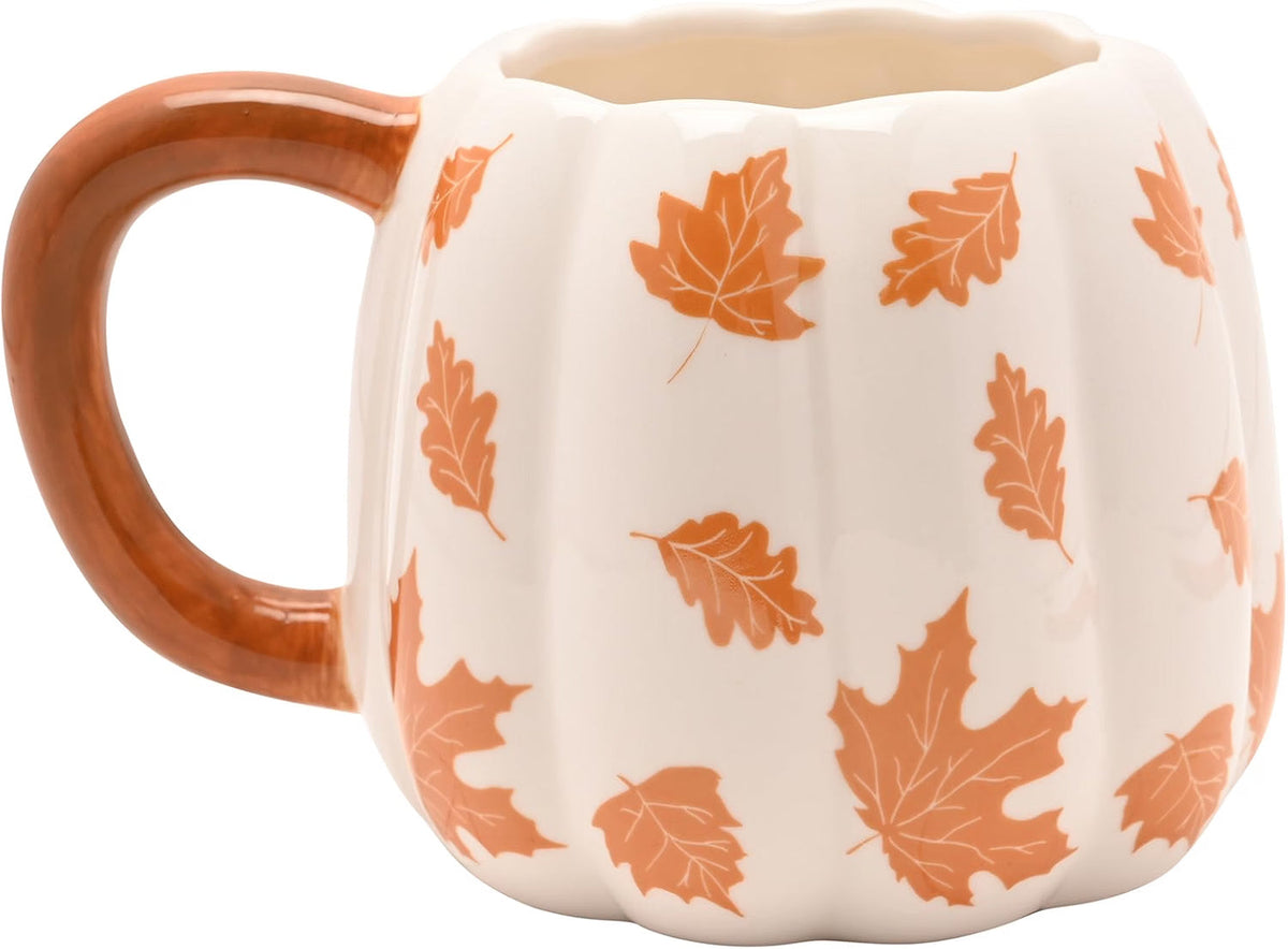A ceramic pumpkin-shaped mug with a brown handle and base, decorated with an orange autumn leaf pattern on a cream background.