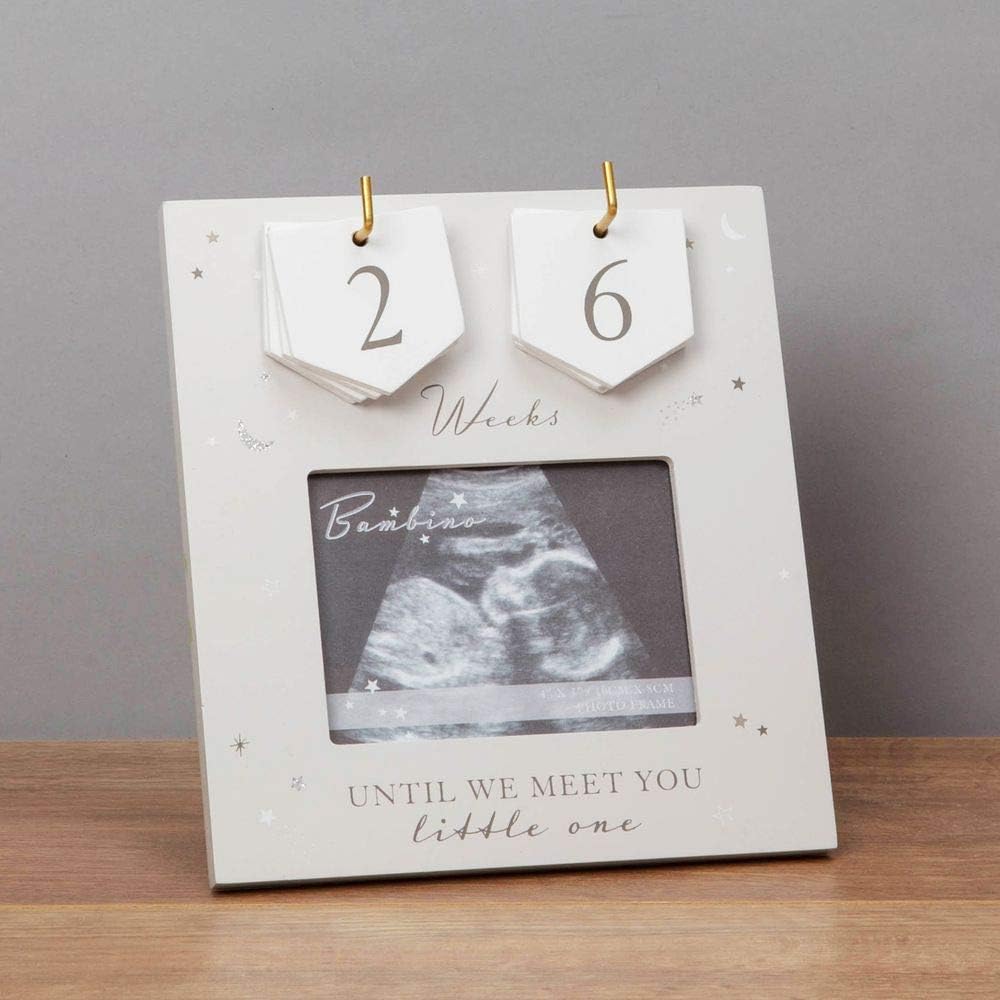 Baby countdown frame with ultrasound photo and 'Until we meet you, little one' text on a wooden surface.