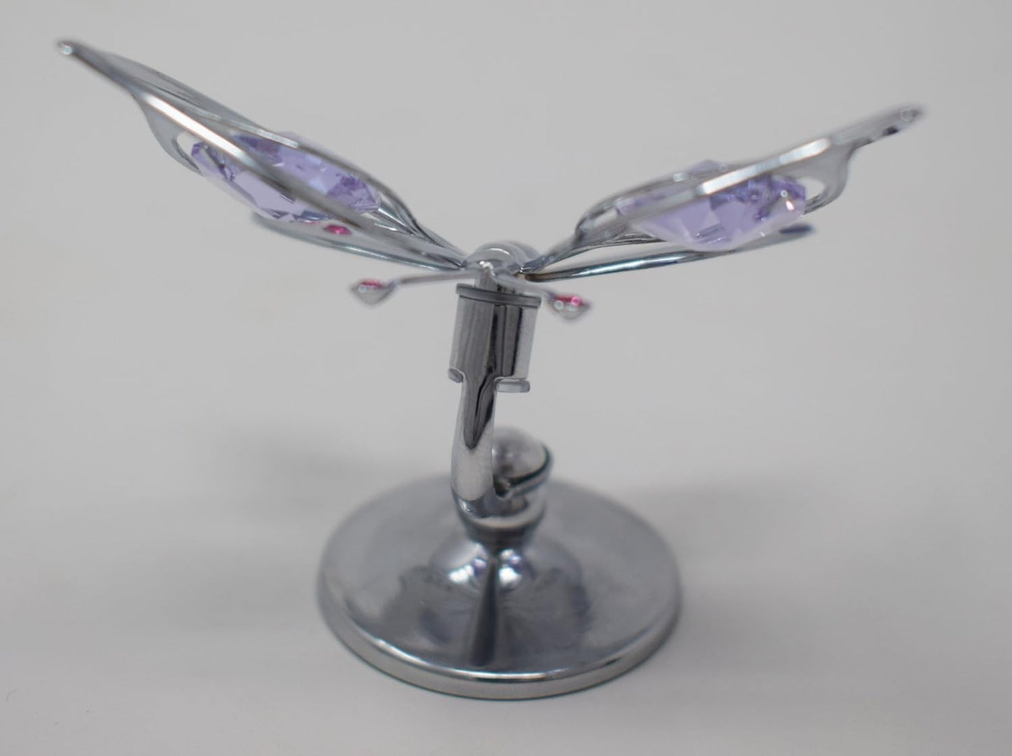 Chrome Butterfly emblem with purple accents on a grey background
