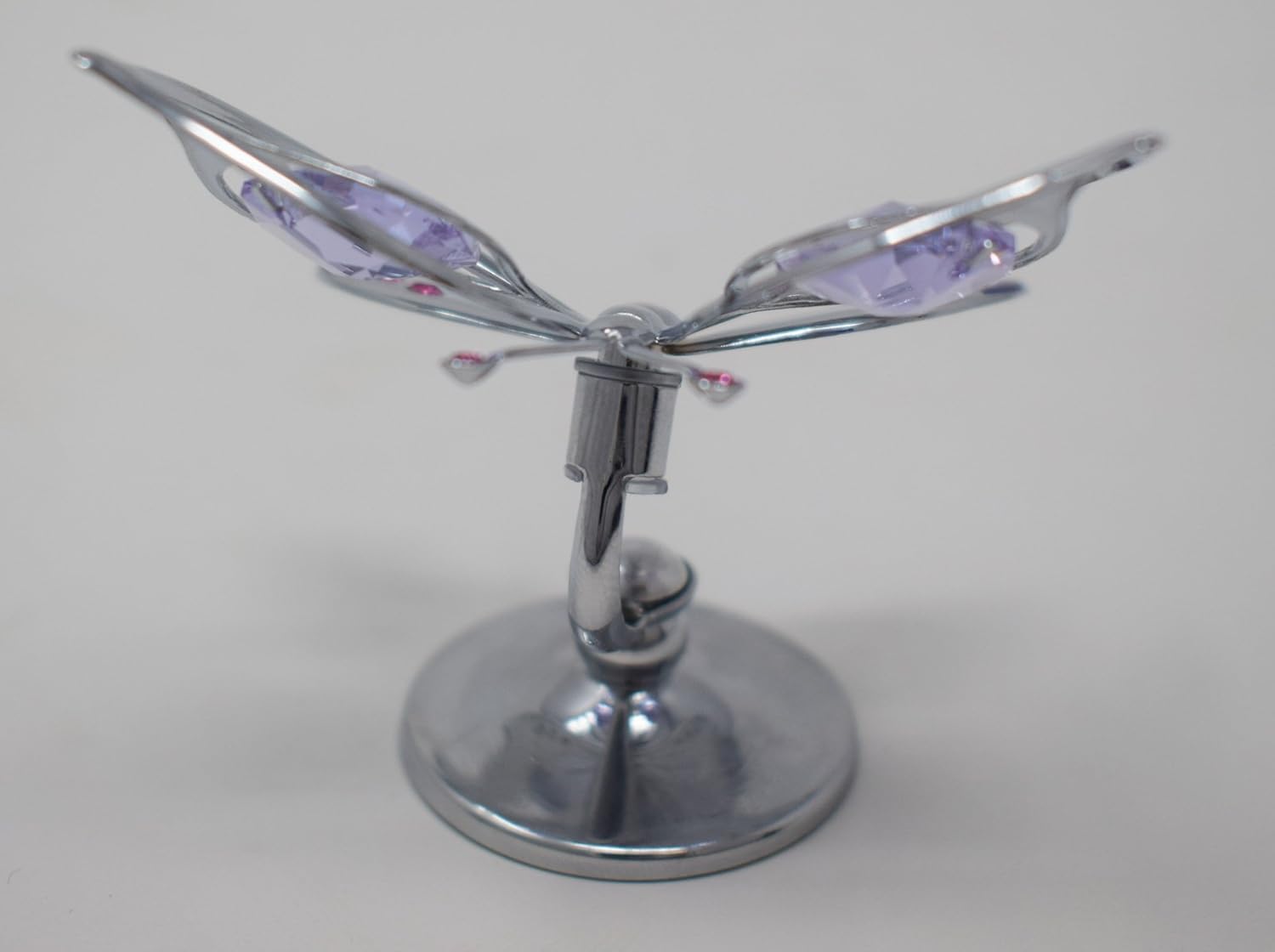 Chrome Butterfly emblem with purple accents on a grey background