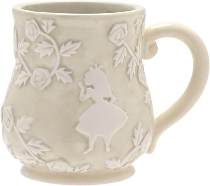 White ceramic mug with floral and silhouette design on a white background