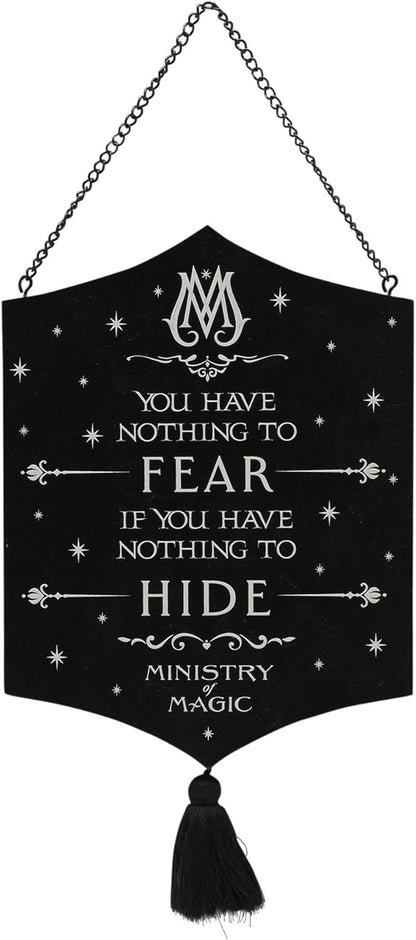 A black hanging banner sign with a black tassel and chain, featuring white gothic text that reads 'YOU HAVE NOTHING TO FEAR IF YOU HAVE NOTHING TO HIDE' and 'MINISTRY OF MAGIC' with decorative stars and ornamental flourishes.