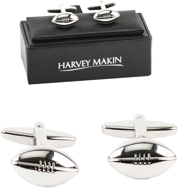 Silver Rugby-shaped cufflinks with a black box labeled 'Harvey Makin' on a white background.