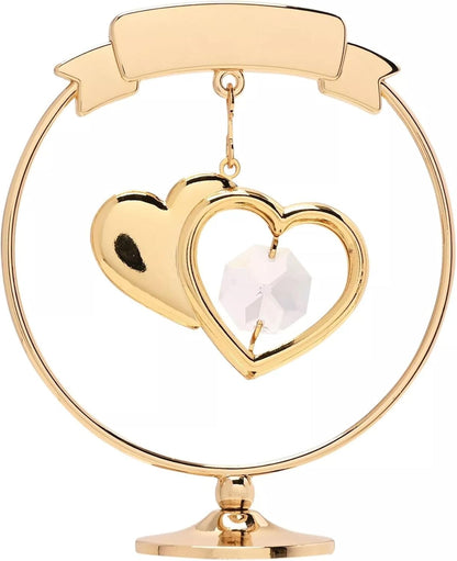 Gold heart-shaped ornament with a white center on a white background