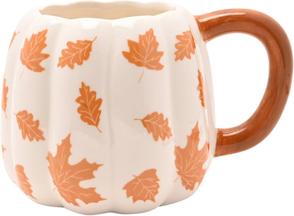 A pumpkin-shaped ceramic mug with a ribbed white body, orange maple leaf pattern, and a glossy brown handle, shown on a plain white background.