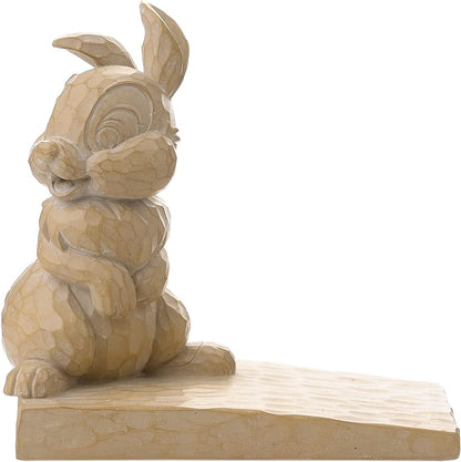 Wooden rabbit door stop on a white background