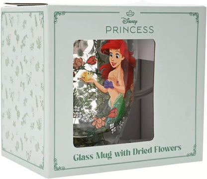 Disney Princess glass mug with dried flowers, shown inside its light green and white retail packaging box with a clear window displaying the illustrated mug.