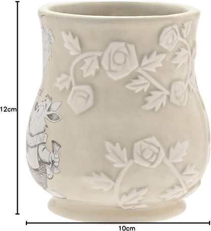 White ceramic mug with floral embossing and measurements on a white background
